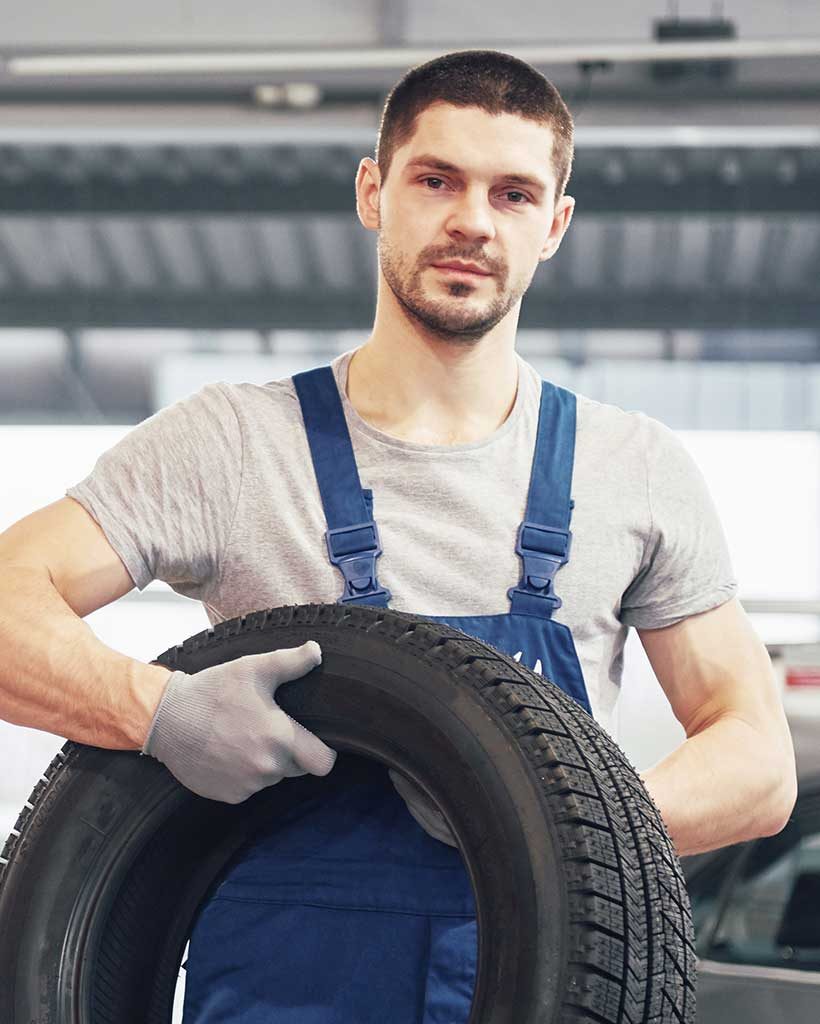 Mobile Tire Service Provider Gripping a Car Tire